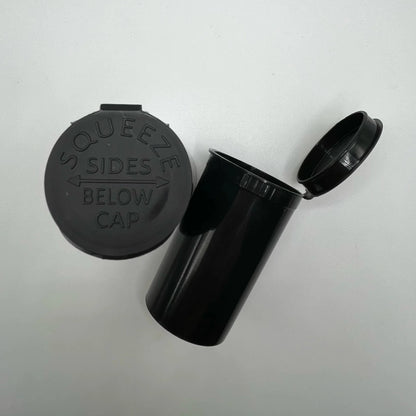 Black plastic container with cap on a white background