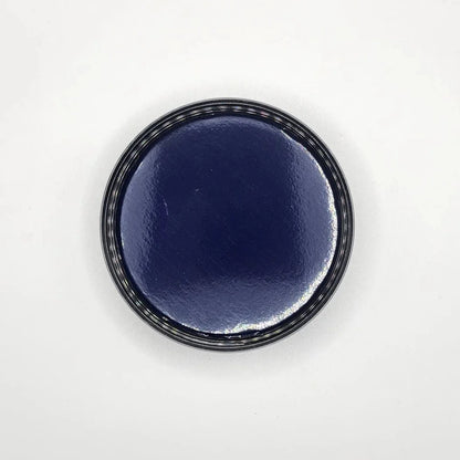 Round black glass jar on a white background