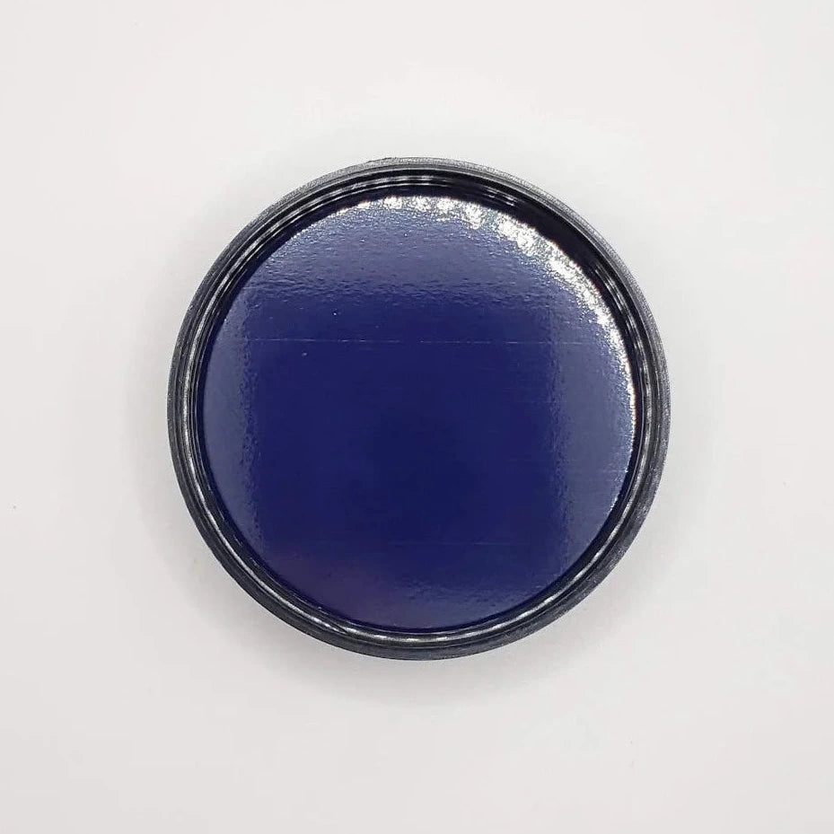 Round black jar lid on a white background