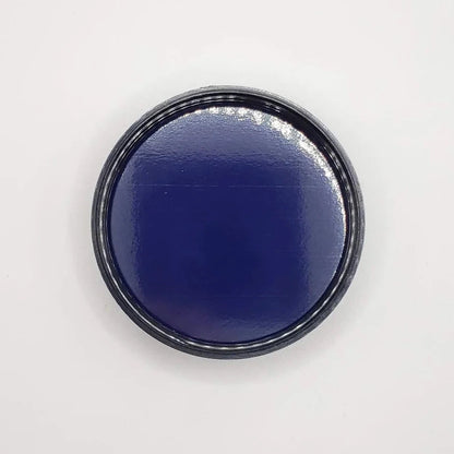 Round black jar lid on a white background