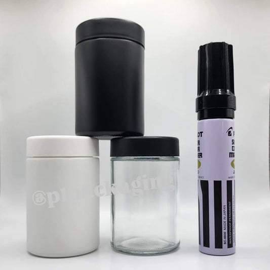 Collection of black, white, and clear containers on a white background