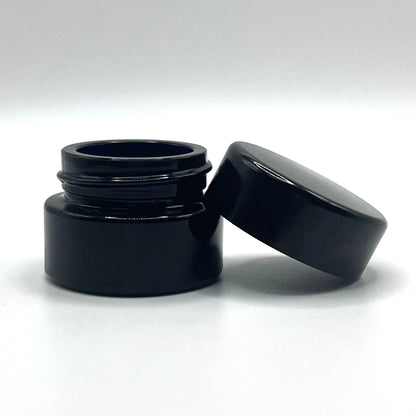 Black plastic container with lid on a white background