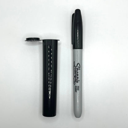 Black Sharpie marker next to a black tube on a white background