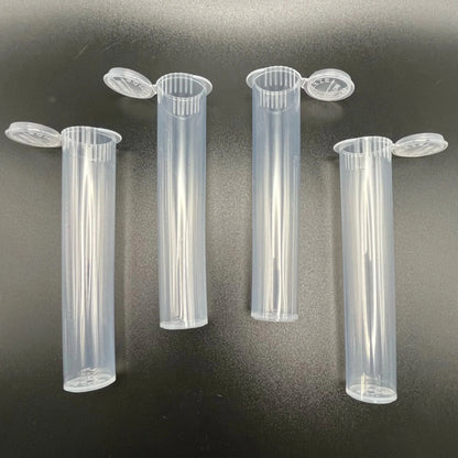 Four clear plastic tubes with lids on a dark background
