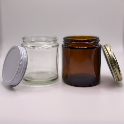 Two different colored glass jars with different colored lids on a white background