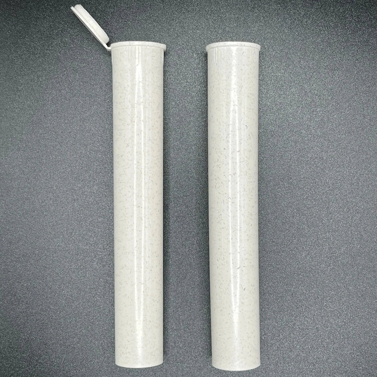 Two cylindrical white objects with a textured surface on a gray background