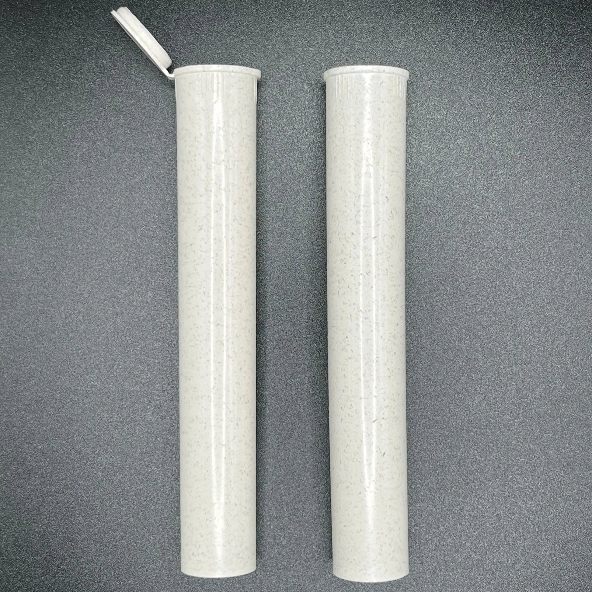 Two cylindrical white objects with a textured surface on a gray background