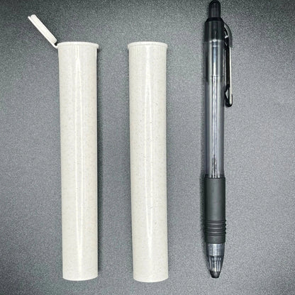 Two cylindrical white tubes and a black pen on a gray surface