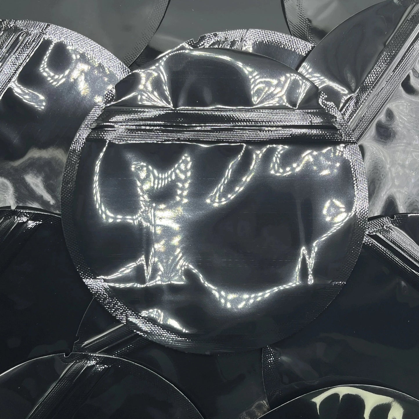 Black circle mylar bags on top of mylar bags