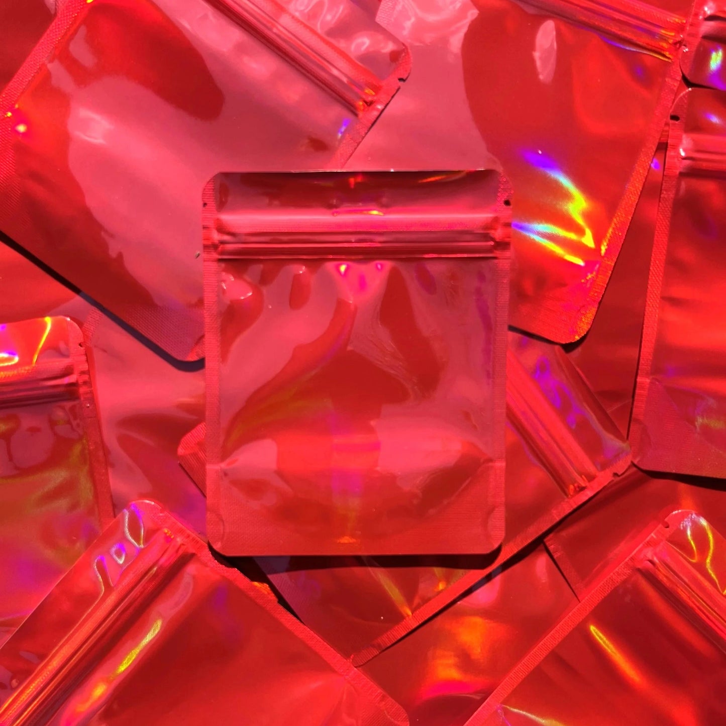 Cherry Red Holographic 4x5 mylar bag on top of mylar