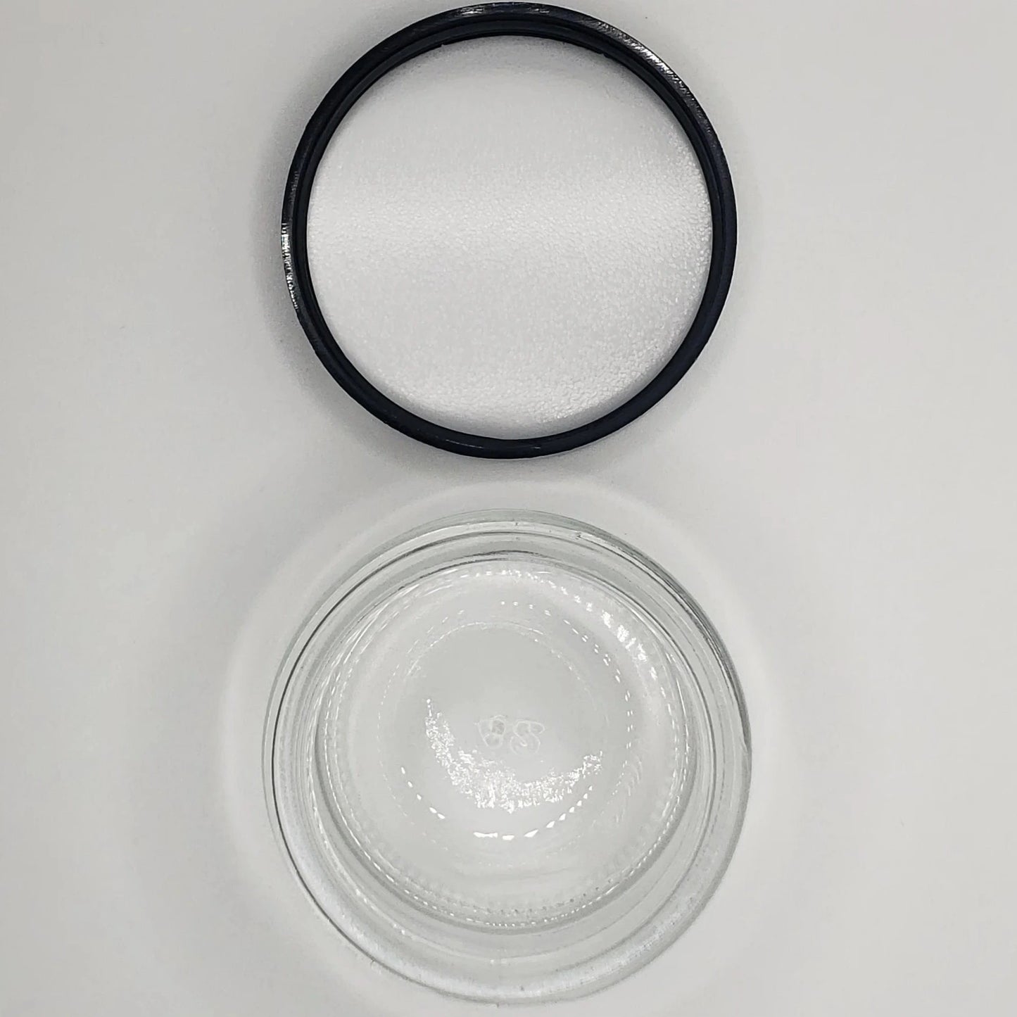 Black rubber gasket and glass jar on a white background