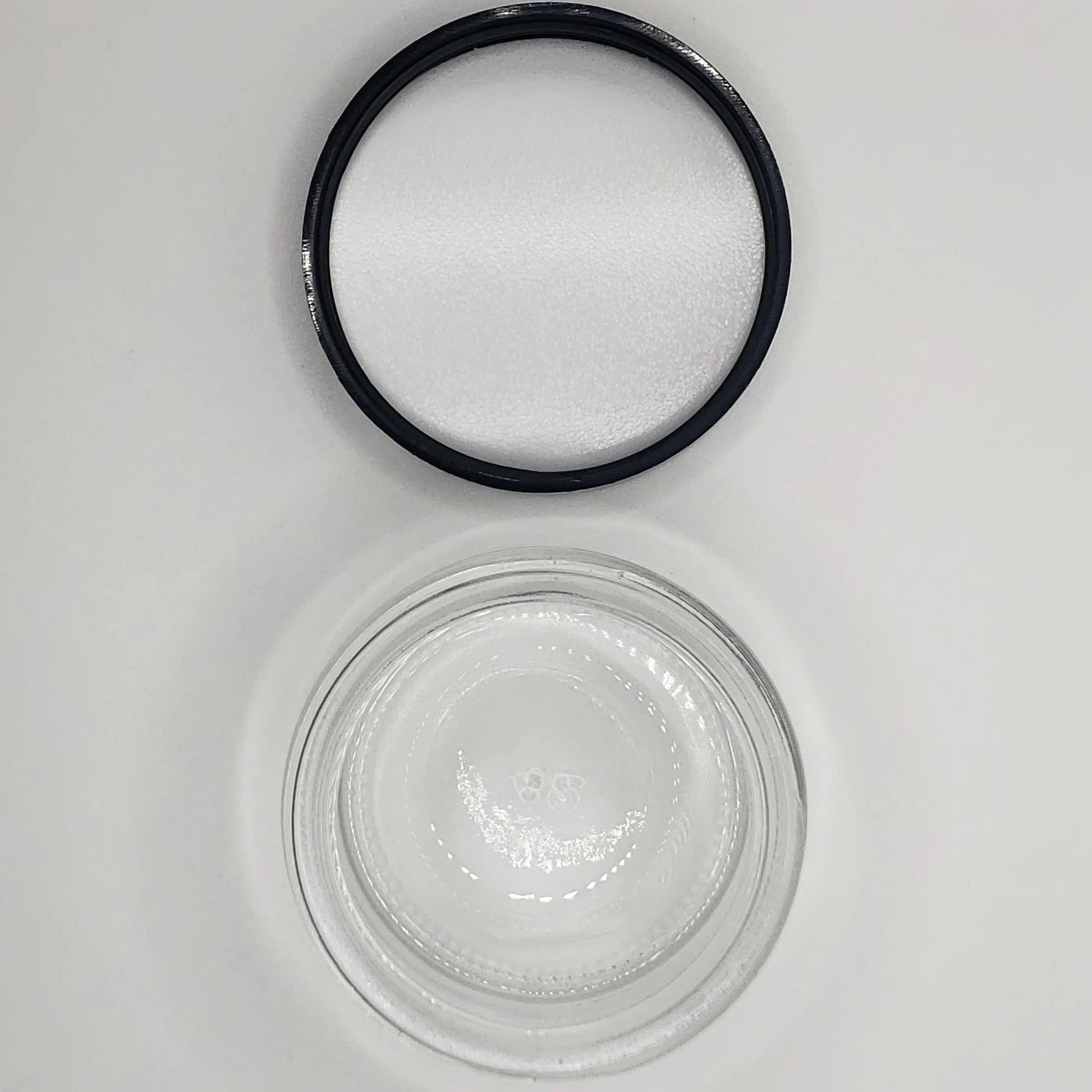 Black rubber gasket and glass jar on a white background
