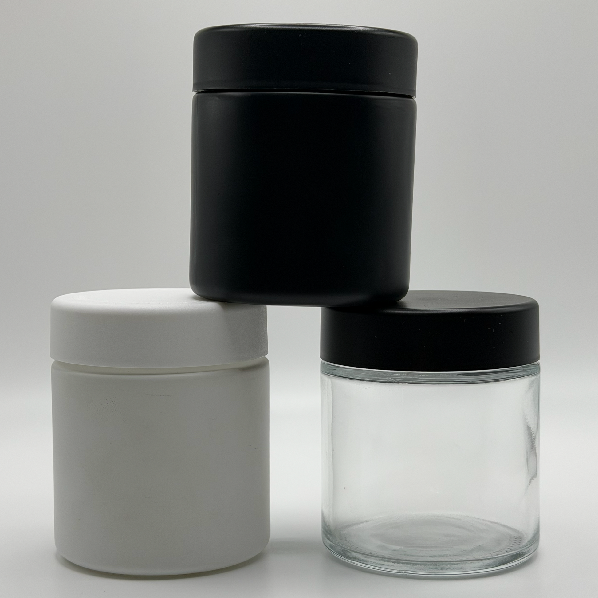 Three 3oz CR glass jars in front of a white background