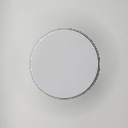 Round white lid on a light gray background