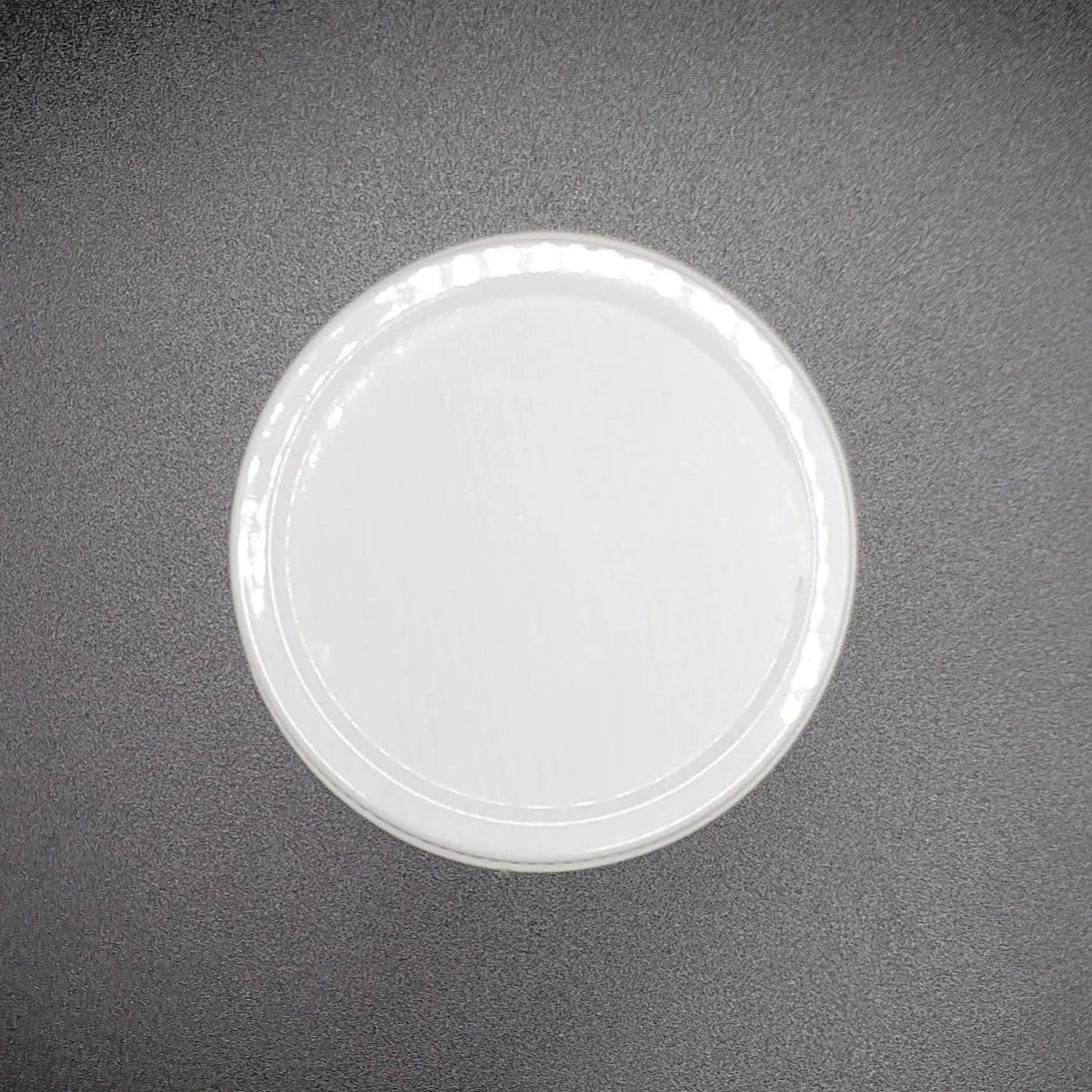 White circular lid on a dark gray background