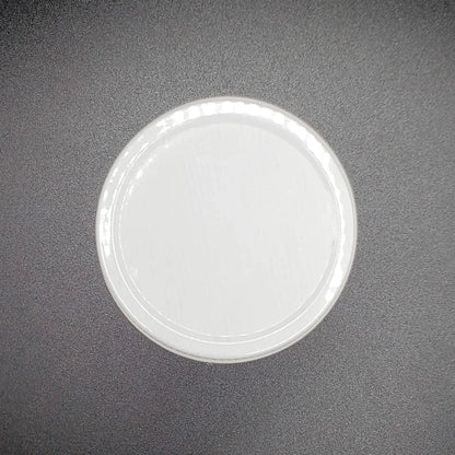 White circular lid on a dark gray background