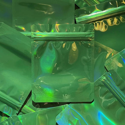 Coffee Shop Green Holographic 4x5 mylar bag on top of mylar