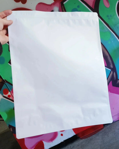 White size P mylar bag held by a hand against a colorful background