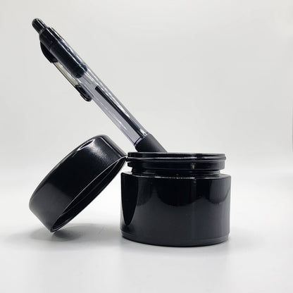 Black pen and black glass jar on a white background