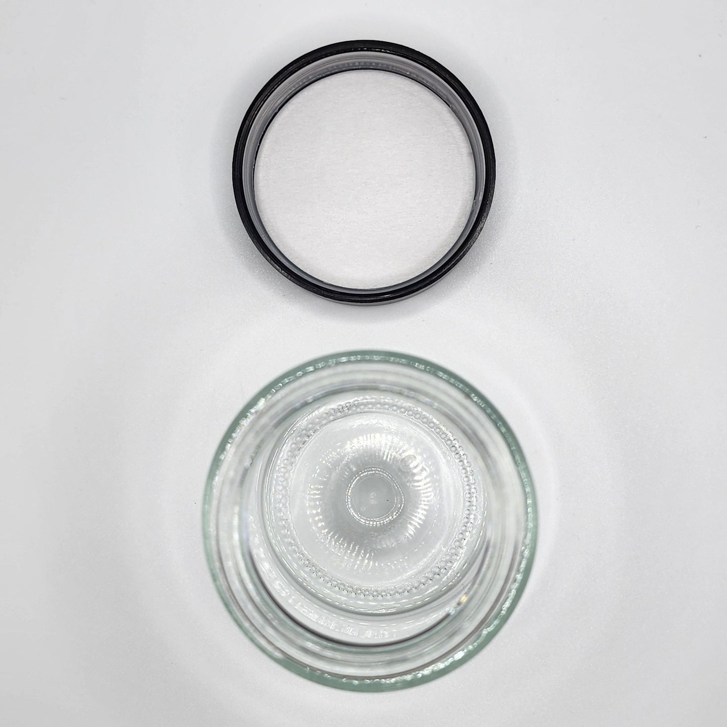 Clear glass bowl with black rubber gasket on a white background
