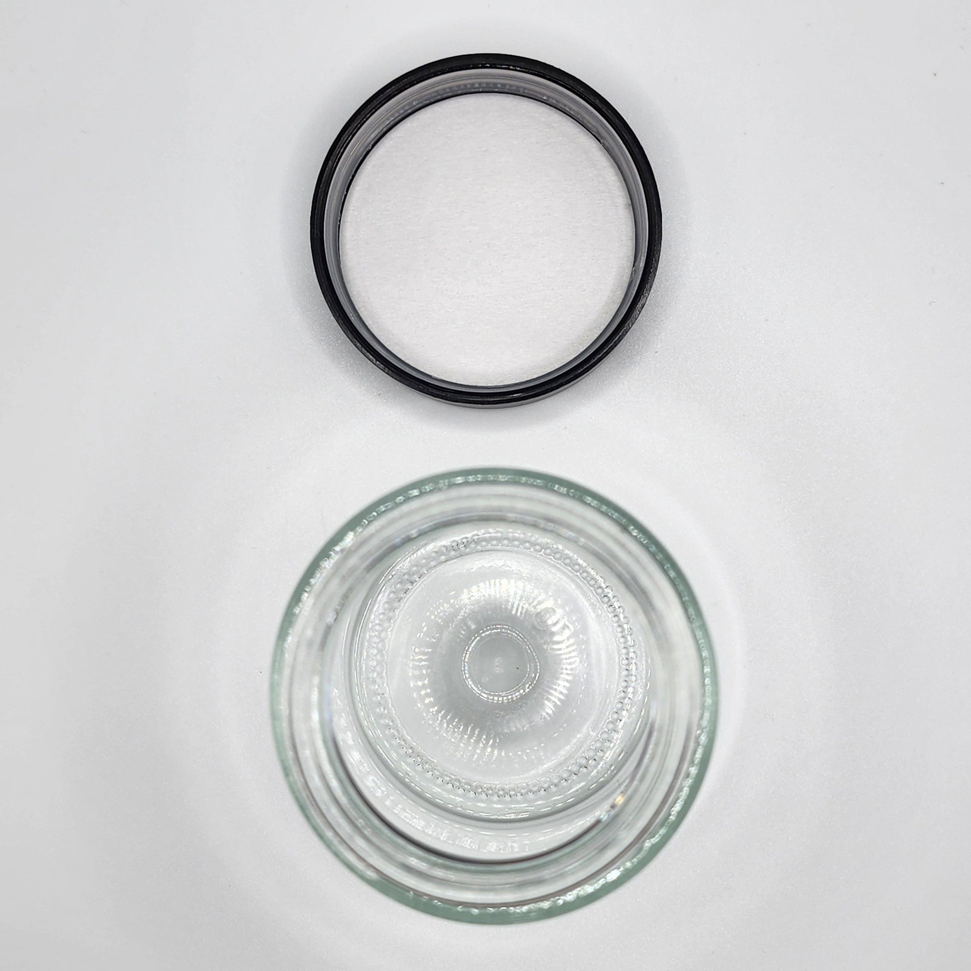 Clear glass bowl with black rubber gasket on a white background