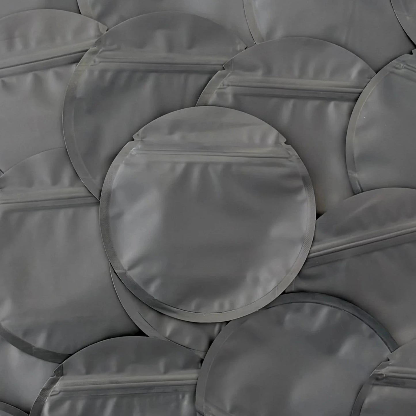 Circle black mylar bag on top of other mylar bags