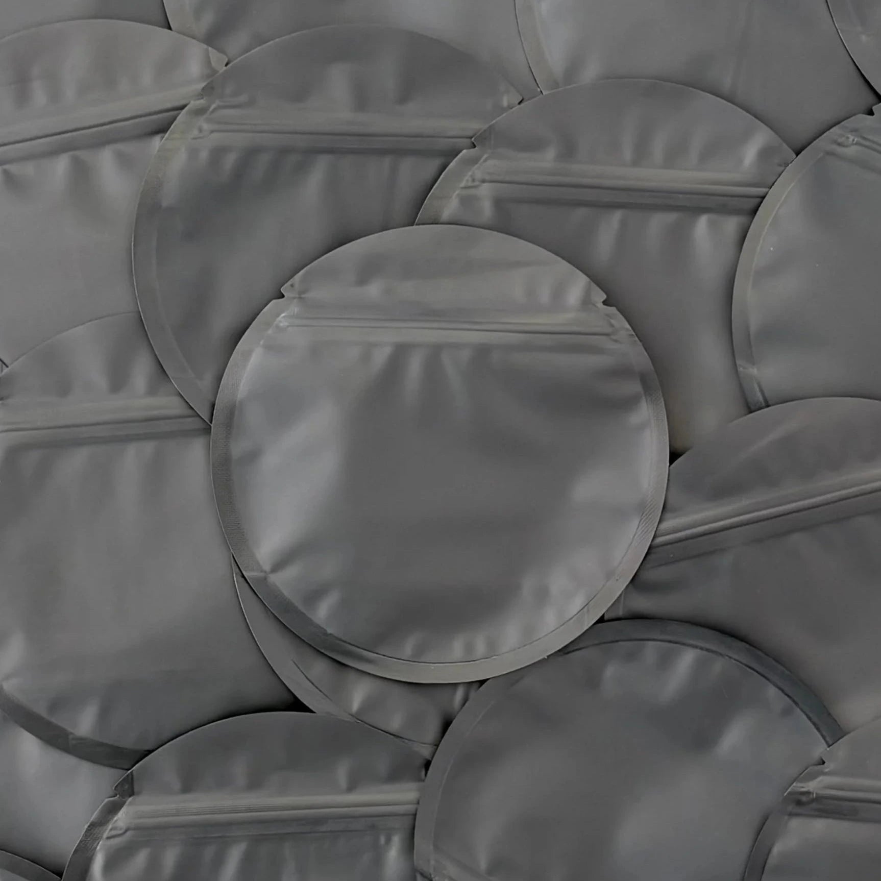 Circle black mylar bag on top of other mylar bags
