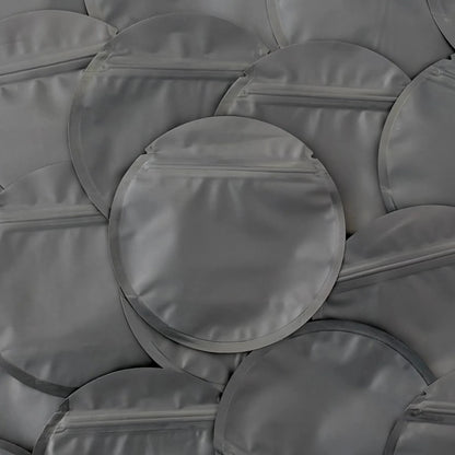 Circle black mylar bag on top of other mylar bags
