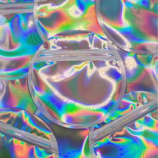 Silver holographic round mylar bag on top of other bags
