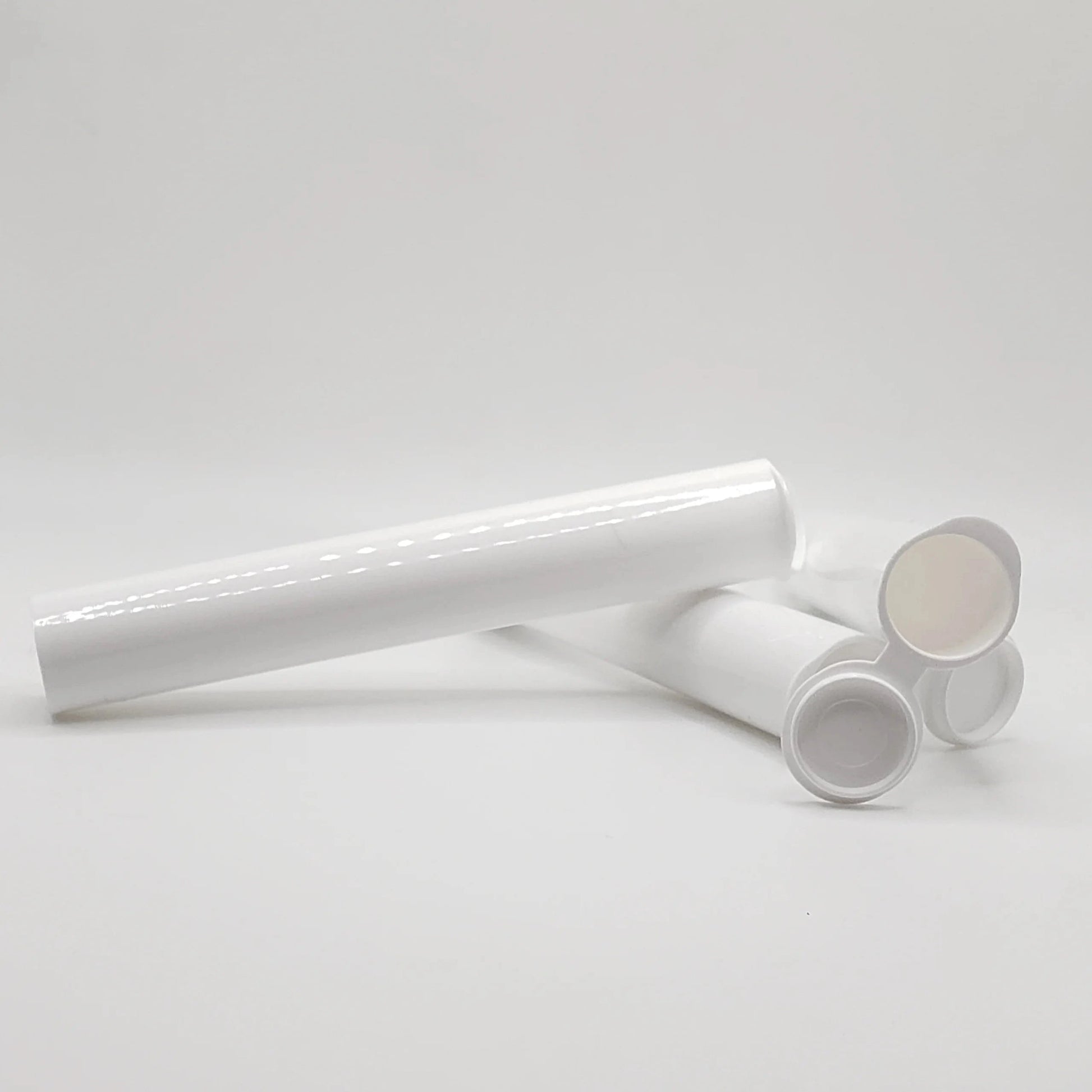 White cylindrical objects on a light gray background